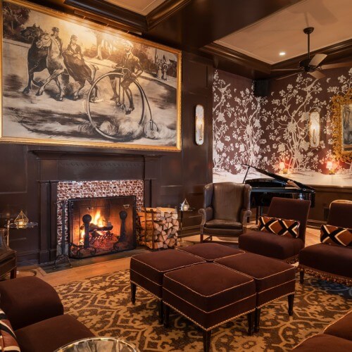 the brown room fireplace next to leather chair