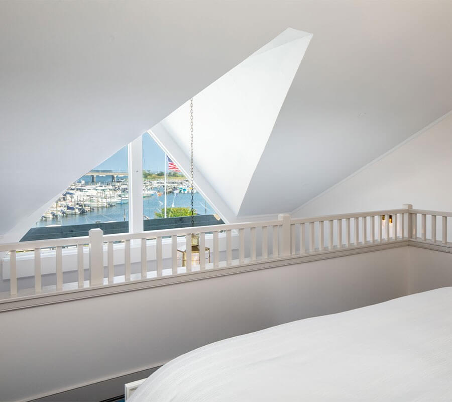 triangular window overlooking a harbor with boats