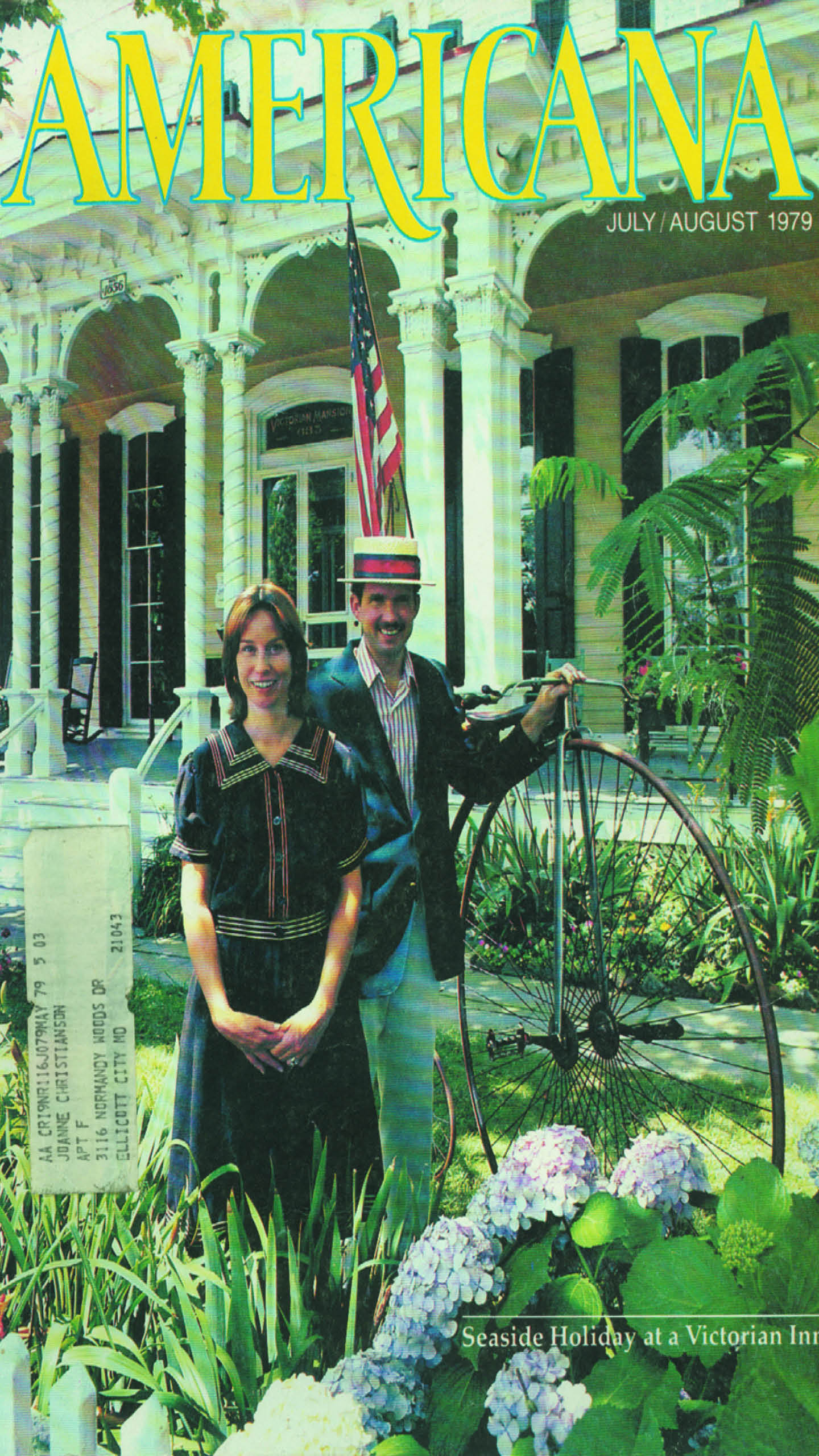 A historic picture of a man and woman standing in front of a Victorian style building. 